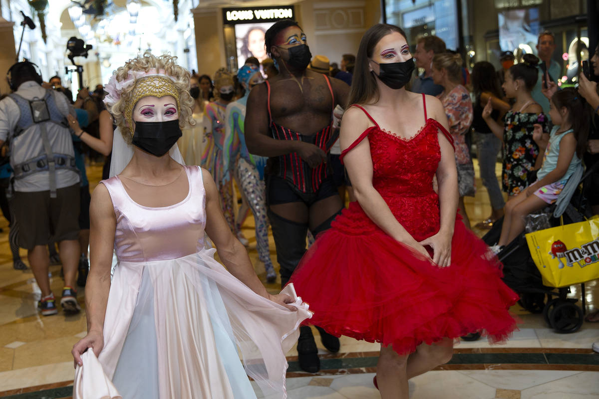 Cast members of "O" walk through Bellagio in a welcome back parade on Thursday, July ...