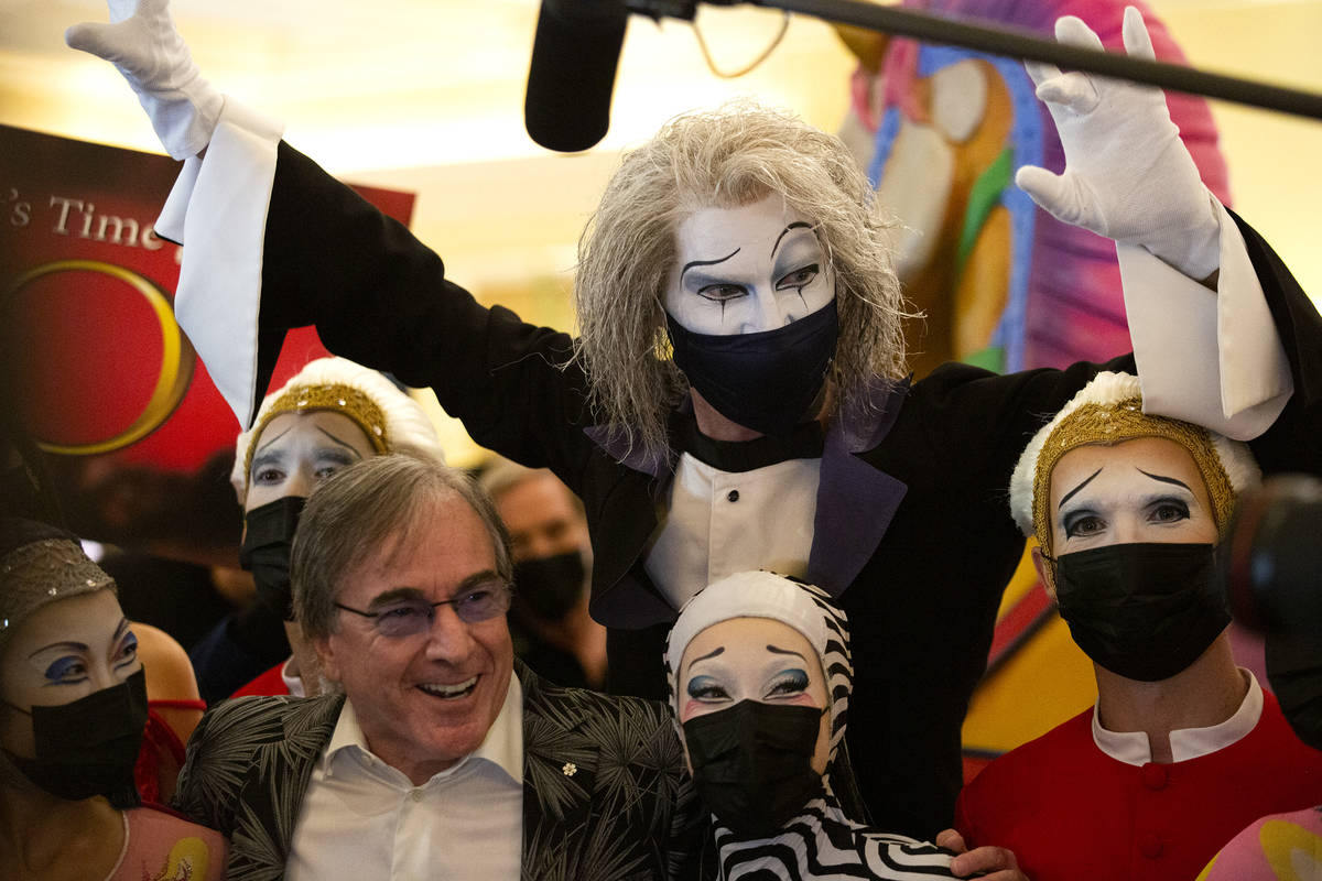 Cast members of "O," and Cirque du Soleil CEO Daniel Lamarre, bottom left, pose for p ...