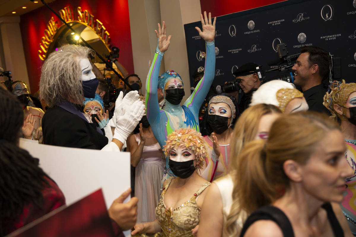 Cast members of "O" cheers as they reach the show's theater during a welcome back par ...