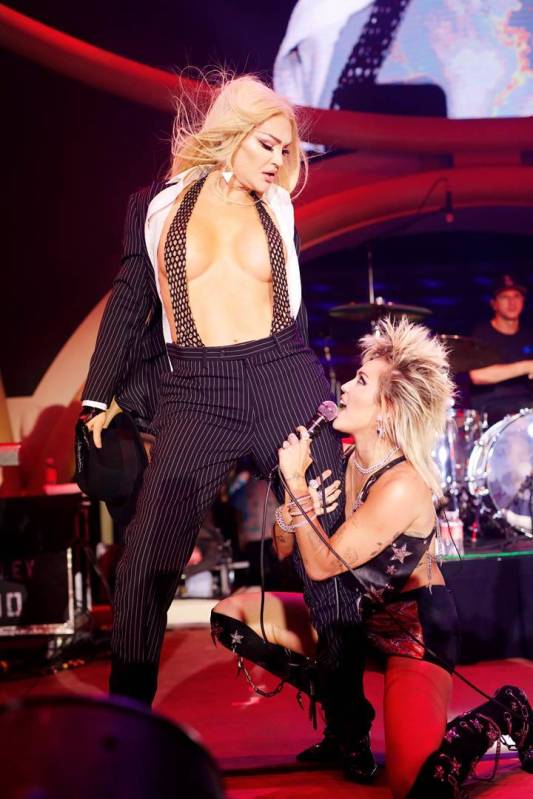 Miley Cyrus is shown with transgender drag queen Sonique during 4th of July grand opening celeb ...