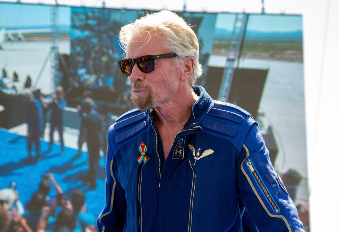 Virgin Galactic founder Richard Branson shows his astronaut wings pin after his flight to space ...