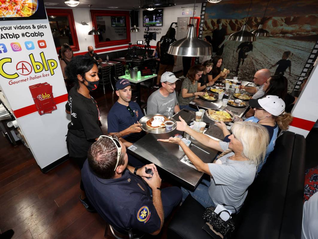 Daijah Miranda serves, from left, Moapa Valley Fire Chief Stephen Neel, firefighter Greg Johnso ...