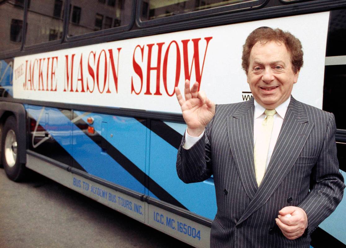 FILE - Actor/comedian Jackie Mason stands beside a bus displaying a sign advertising his TV sho ...