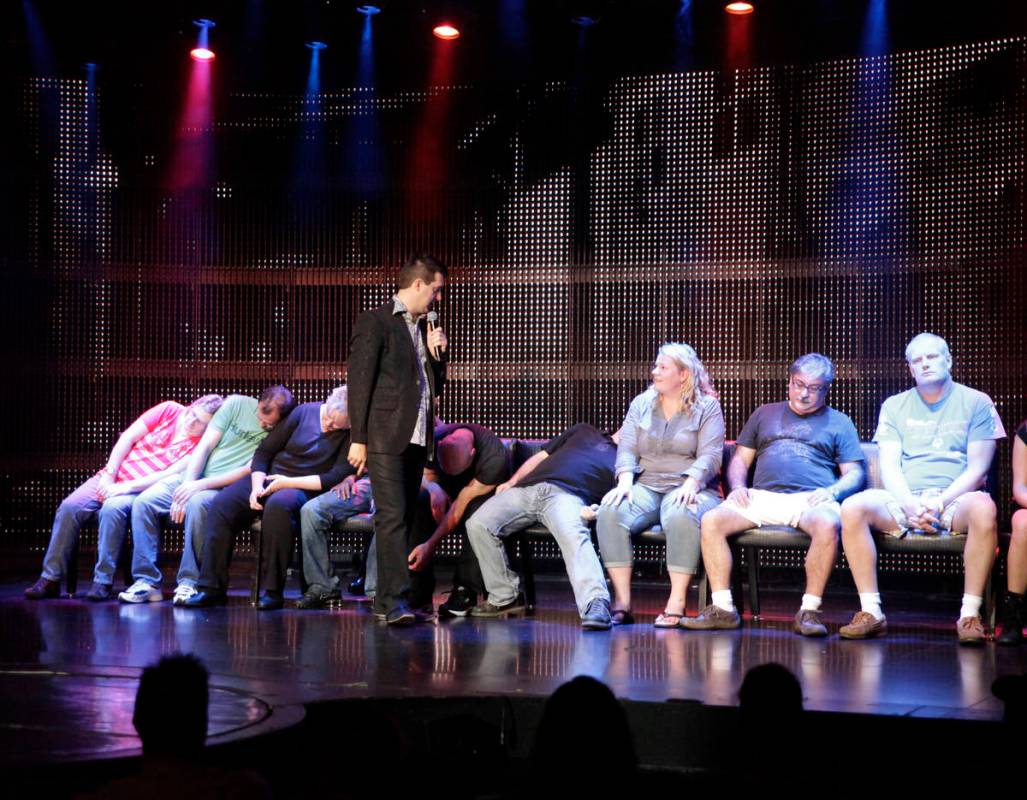 Comic hypnotist Marc Savard talks with volunteer guests before he puts the to “sleep&#x2 ...