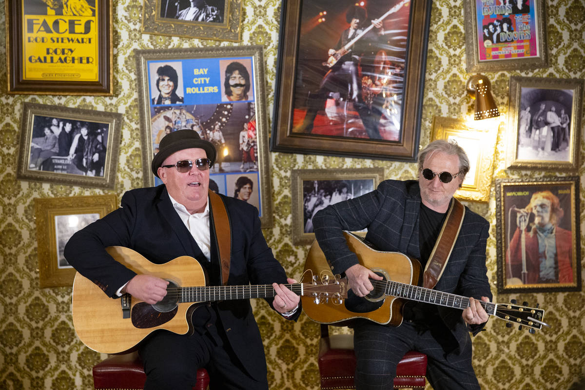 The Black Donnellys, Dave Rooney, left, and Dave Brown, a local Irish music duo, play a song on ...