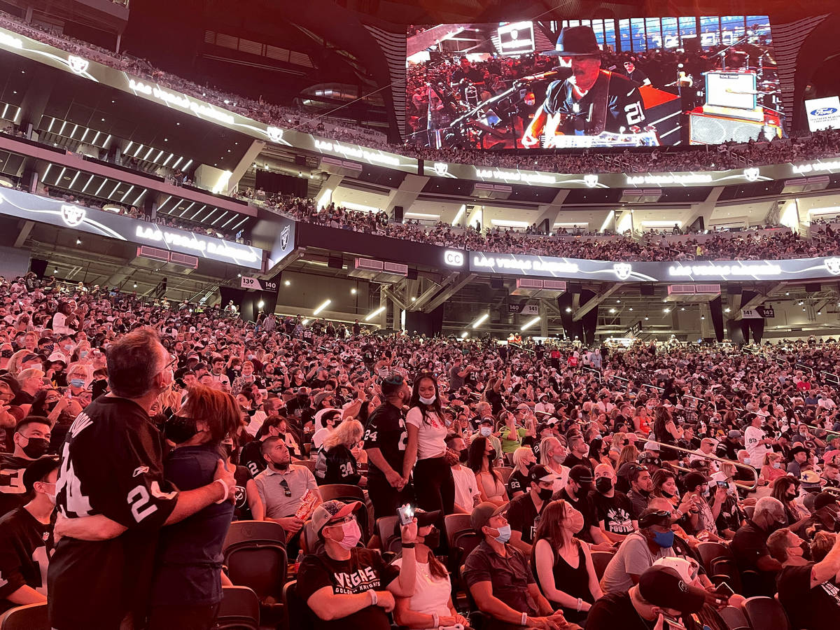 A video screen shows Carlos Santana's performance during halftime of the Raiders home opening p ...