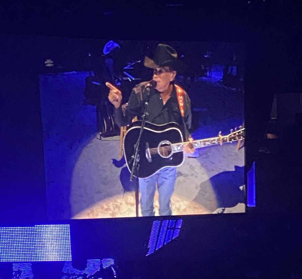 George Strait is shown on the big screen in his return to T-Mobile Arena on Friday, Aug. 13, 20 ...