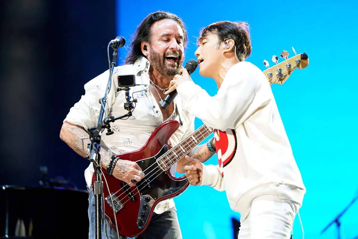 Arnel Pineda, left, and Marco Mendoza of the band Journey perform on day three of the Lollapalo ...