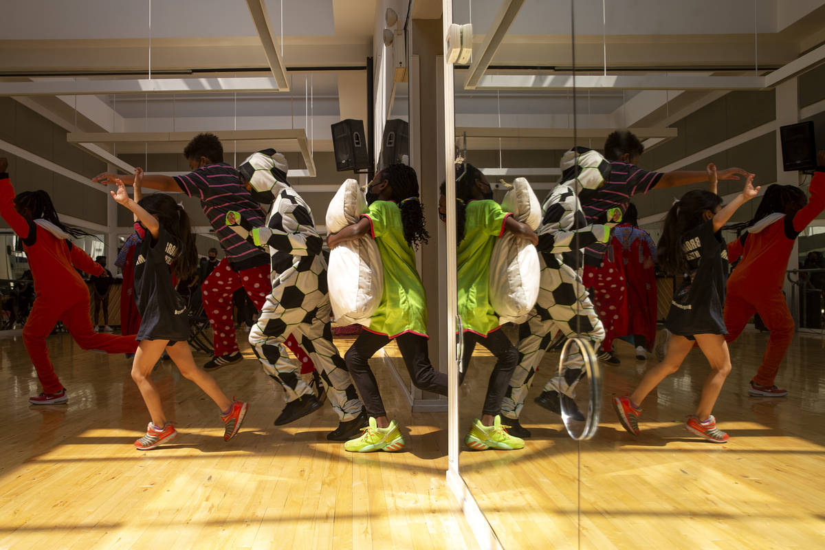 Cast members run out for a dance number during a rehearsal for Broadway in the HOOD's productio ...