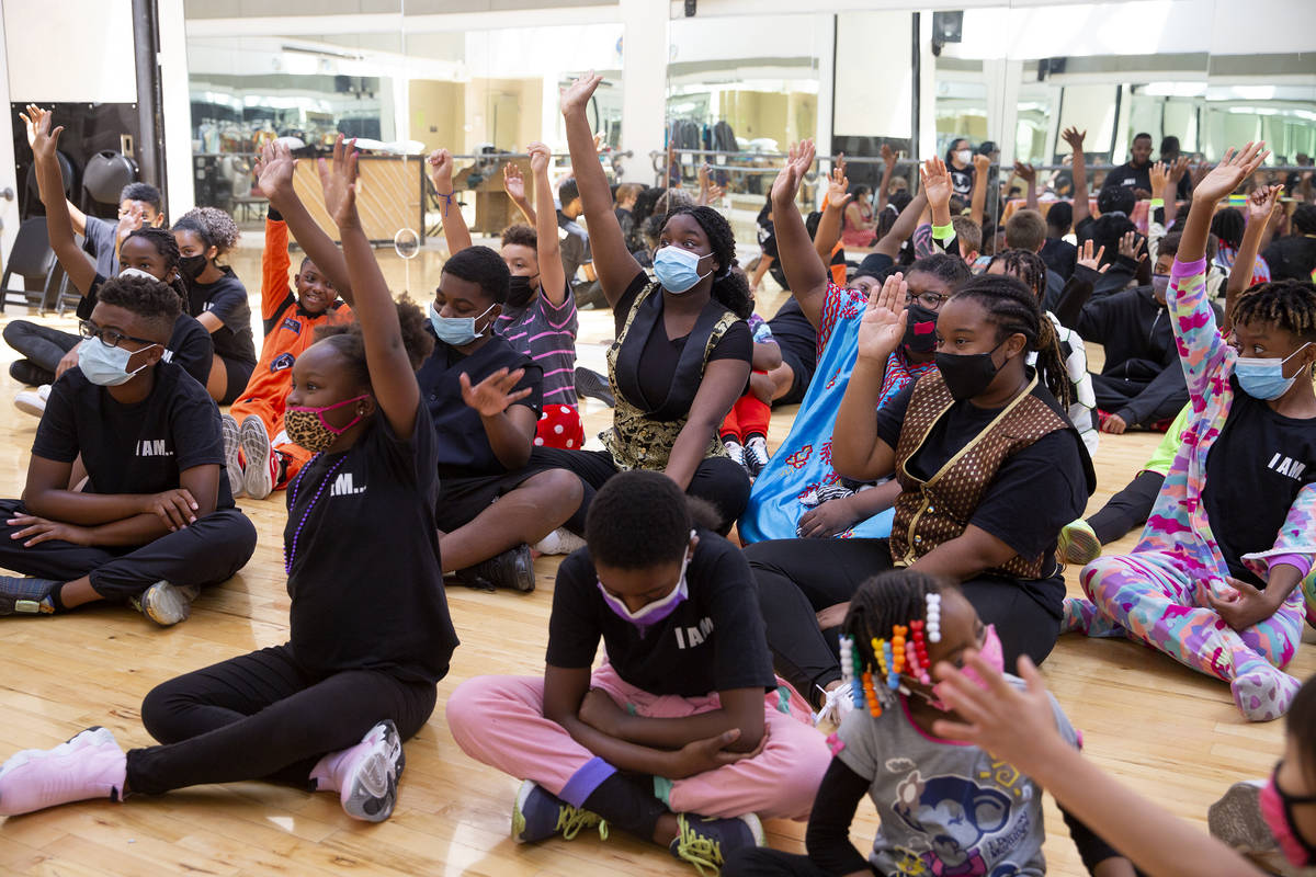 Cast members raise their hands when asked who would like to pursue theater as an adult during a ...