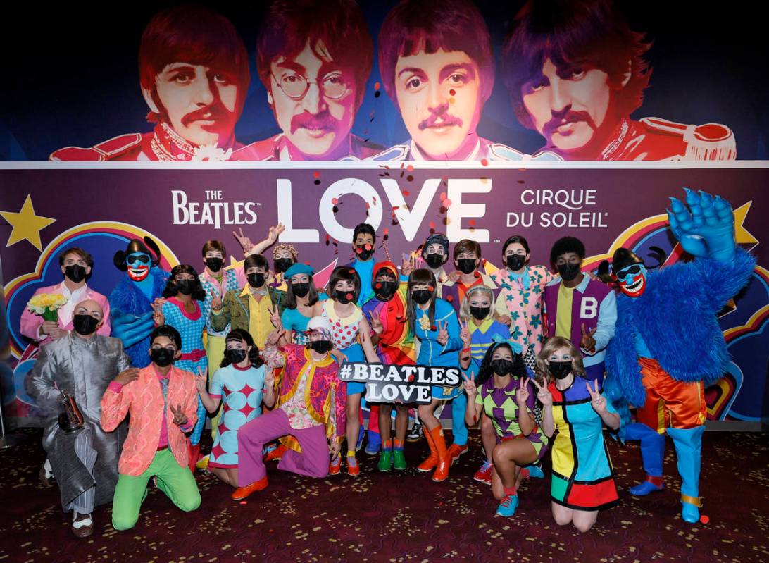 Cast members pose during a pop-up performance before the grand reopening of "The Beatles LOVE B ...