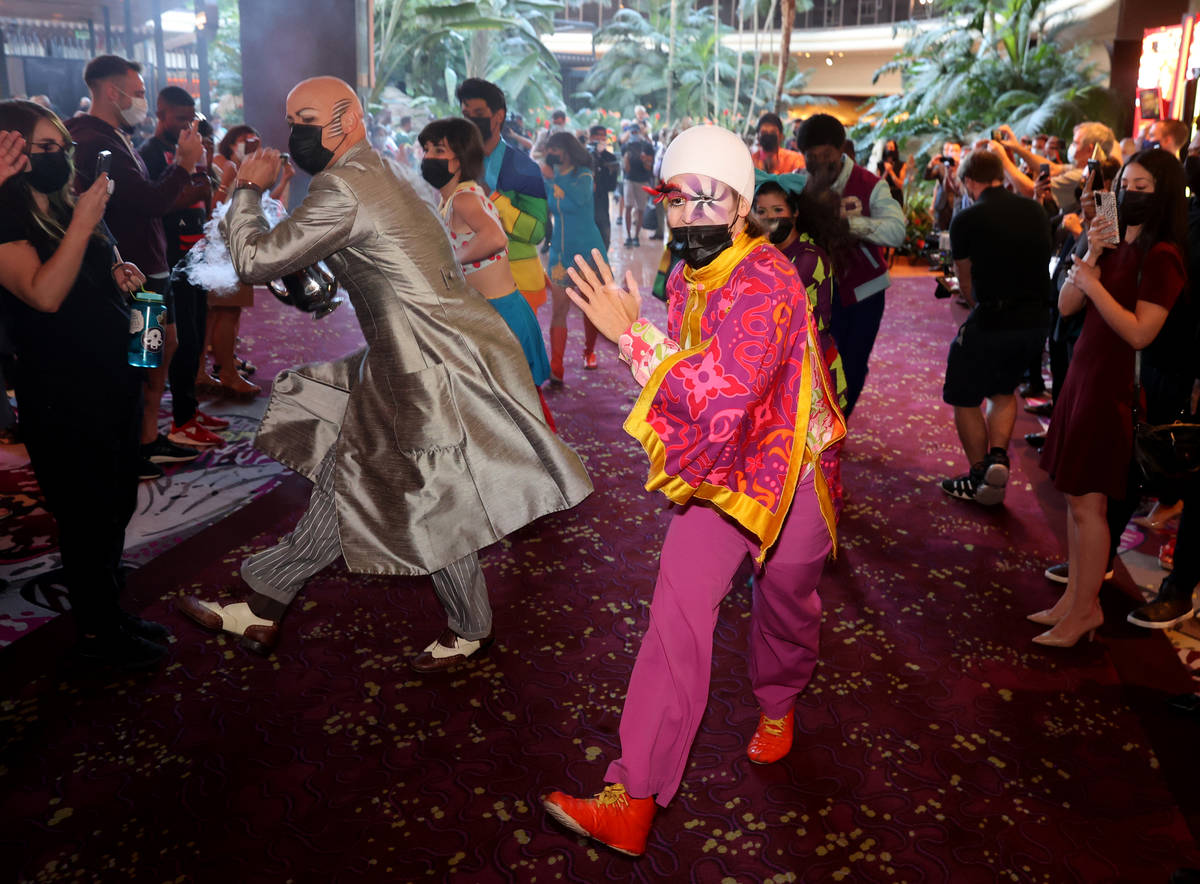 The cast of The Beatles LOVE entertain guests, employees, and fans during a celebratory pop-up ...