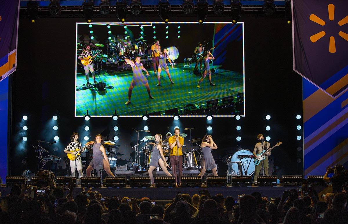 Students dance on stage as the Imagine Dragons perform at a Walmart-sponsored "Homecoming Conce ...