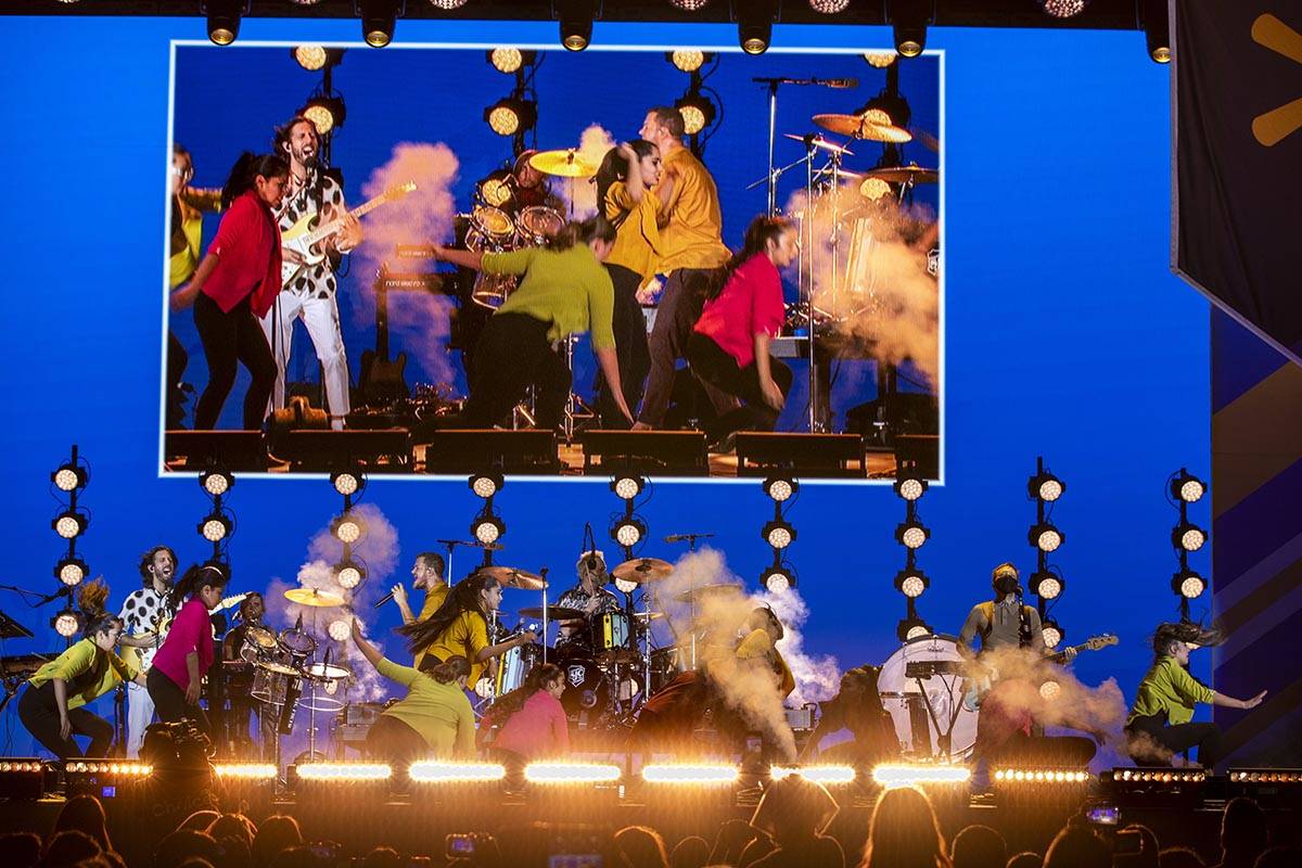 Students dance on stage as the Imagine Dragons perform at a Walmart-sponsored "Homecoming Conce ...