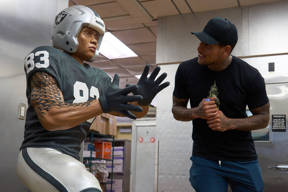 Raiders Darren Waller meets a chocolate statue of himself that will be featured at ARIA Patisse ...