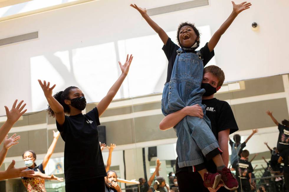 Koston Pobon lifts Micha Marino, who plays Andie, during a rehearsal for Broadway in the HOOD's ...