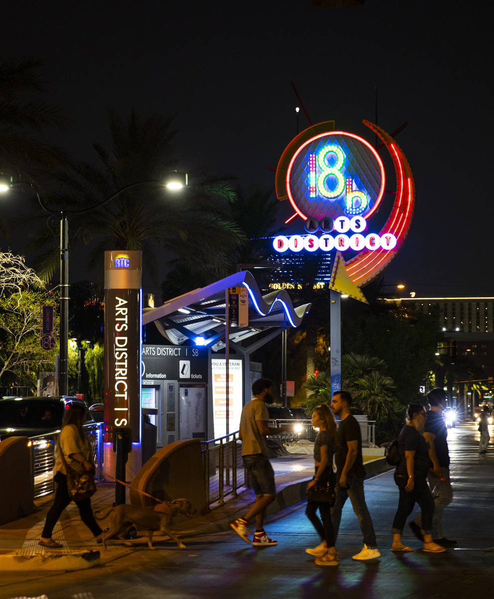 People cross the street near the 18B Arts District neon sign during First Friday in downtown La ...