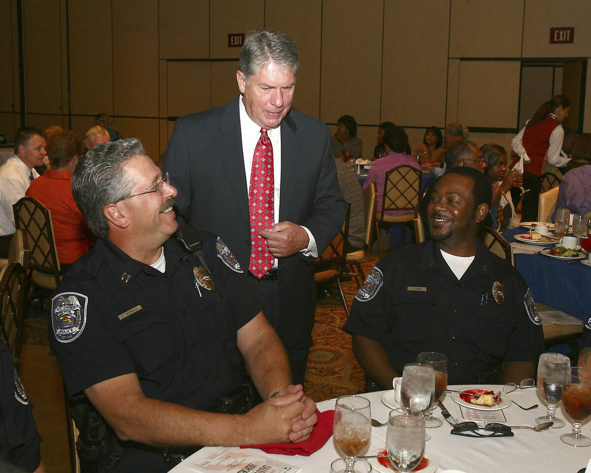 News anchor Gary Waddell, center, talks with North Las Vegas Police Capt. Paul Womacjk and Dep ...
