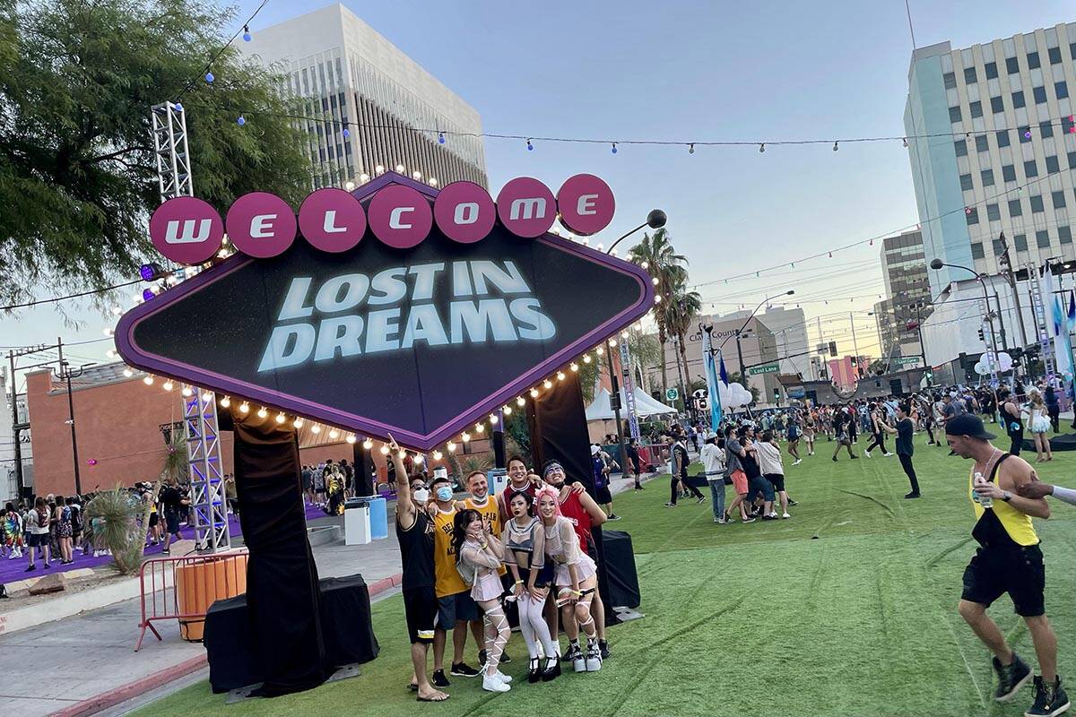 A group poses for photos near the front entrance of Lost in Dreams music festival at the Downto ...