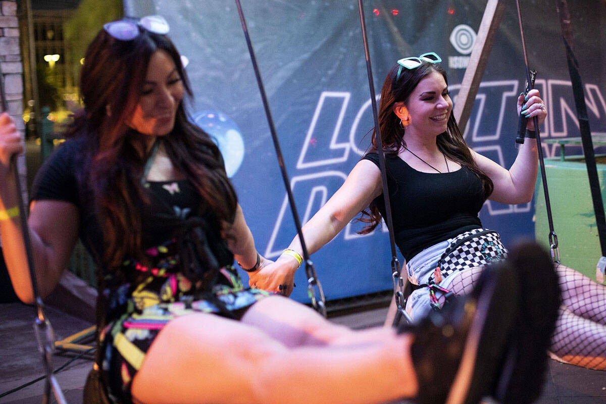 Kristina Arrieta, left, and Rachel Cruz, both of Las Vegas, swing during the Lost in Dreams mus ...