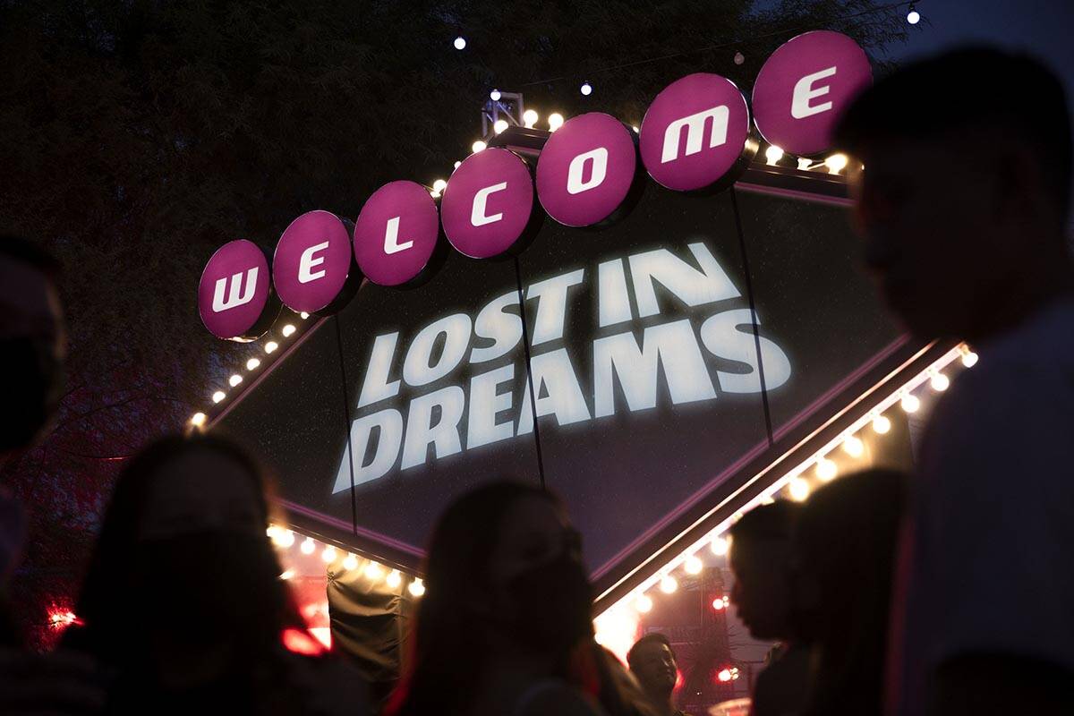 Fans wait in line to take photos in front of the welcome sign during the Lost in Dreams music f ...
