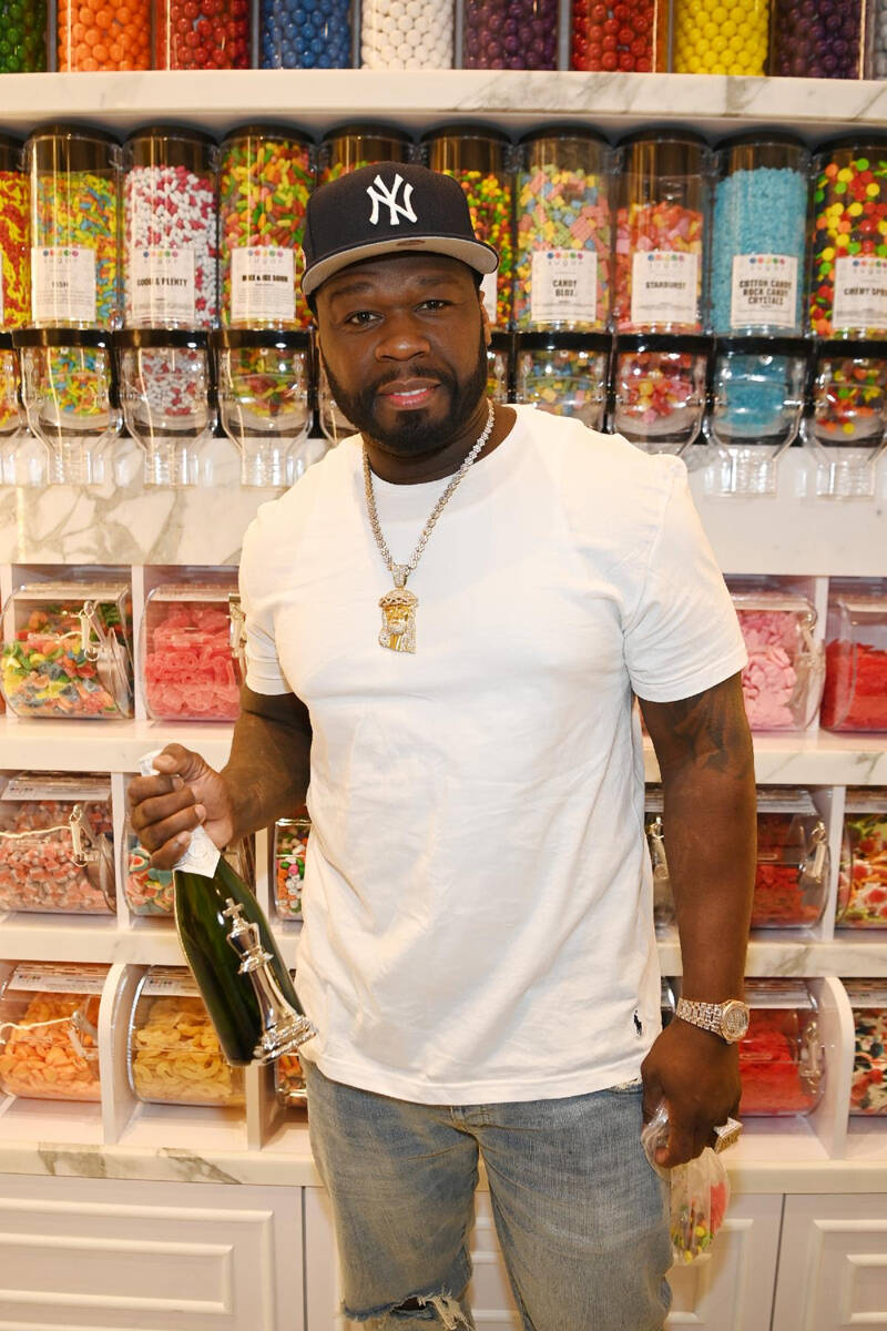 50 Cent poses with Le Chumin Du Roi Brut champagne at Sugar Factory American Brasserie at the H ...