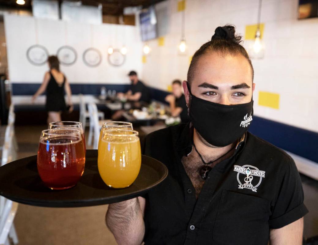 Server Julian Galvan brings drinks to a table at Makers & Finders on Wednesday, Sept. 15, 2 ...