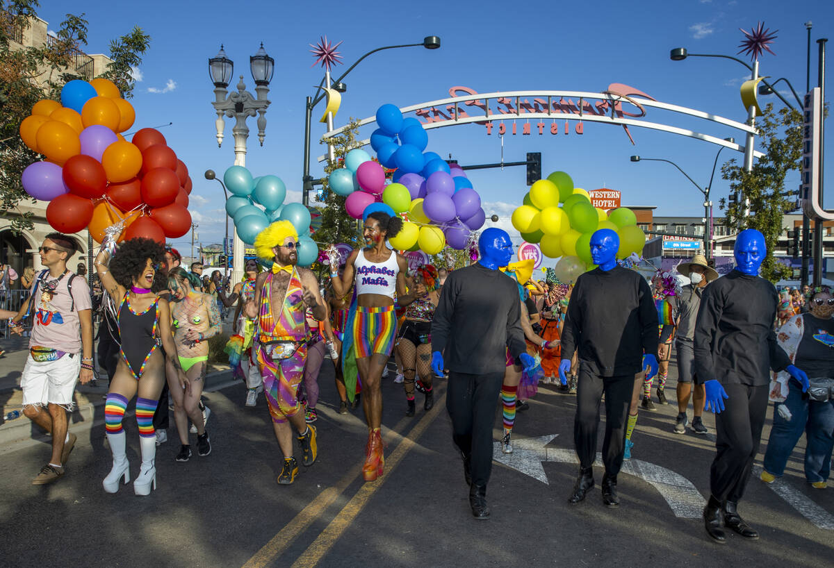 People with The House of Yes and members of the Blue Man Group walk along during a Gay Pride pa ...