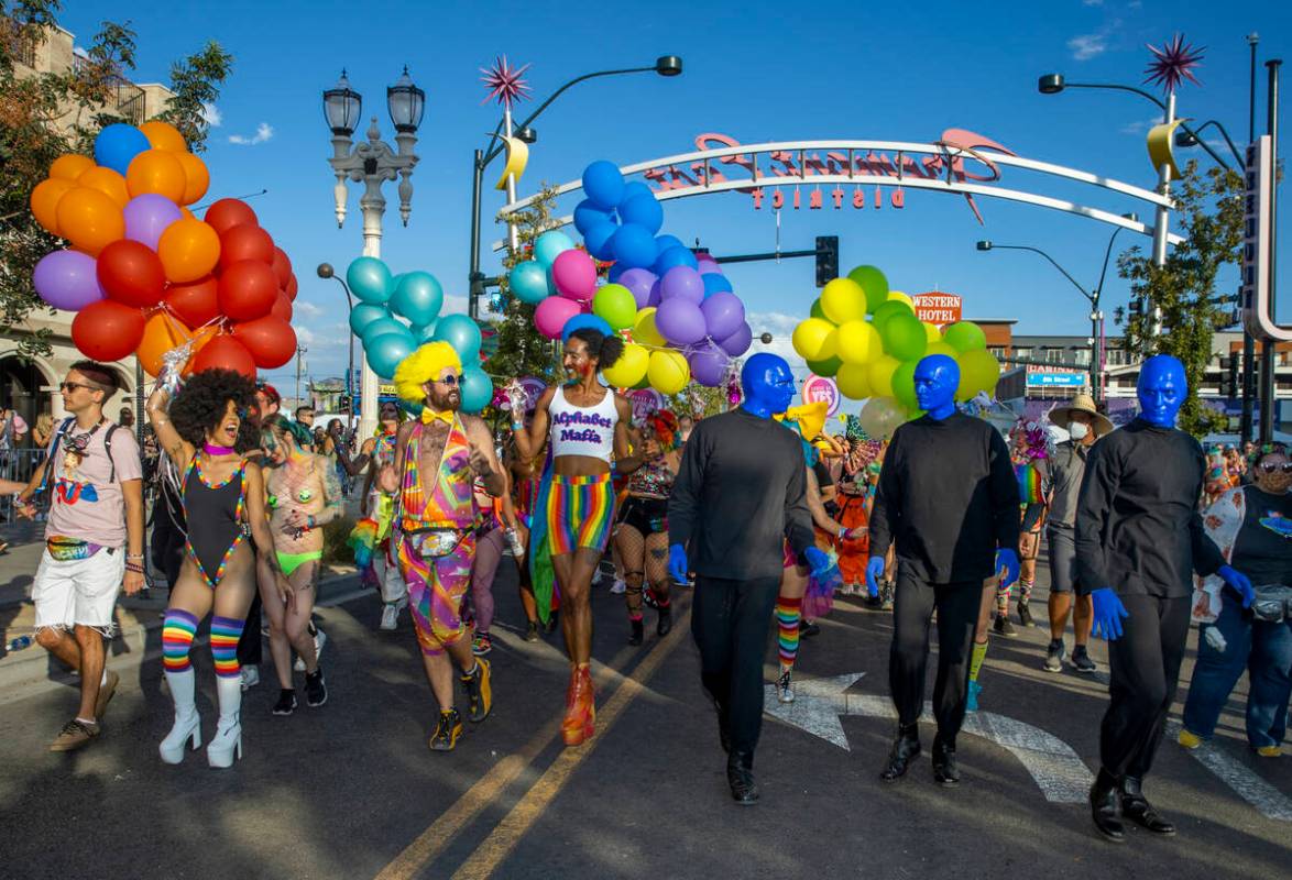 People with The House of Yes and members of the Blue Man Group walk along during a Gay Pride pa ...