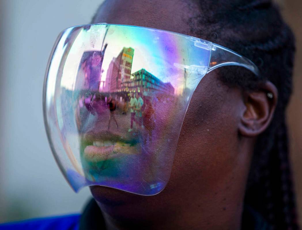 Shelley Ross with CSC Security has attendees reflected in her face shield during day one of Lif ...