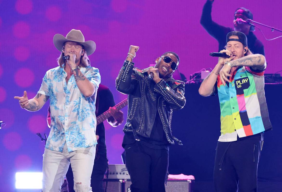 Nelly (C) performs with (L-R) Brian Kelley and Tyler Hubbard of Florida Georgia Line onstage du ...