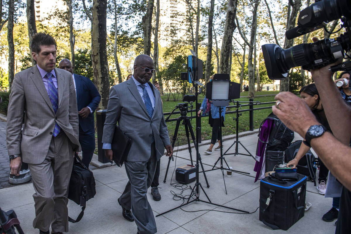 Attorney Deveraux Cannick, representing R&B star R. Kelly, center, arrives at Brooklyn Federal ...