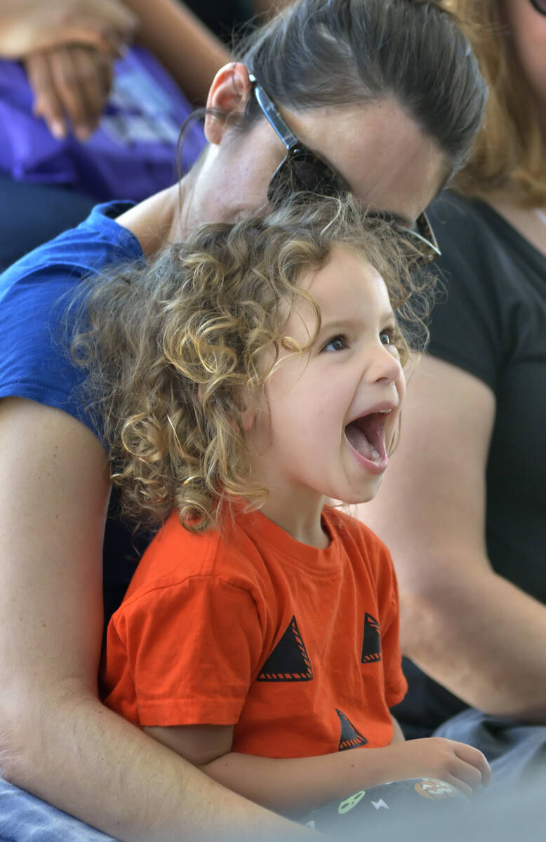 Arta Russell, 3, and her mother Melissa of Las Vegas watch singer-songwriter Lisa Loeb perform ...