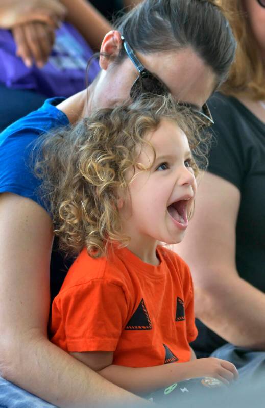 Arta Russell, 3, and her mother Melissa of Las Vegas watch singer-songwriter Lisa Loeb perform ...