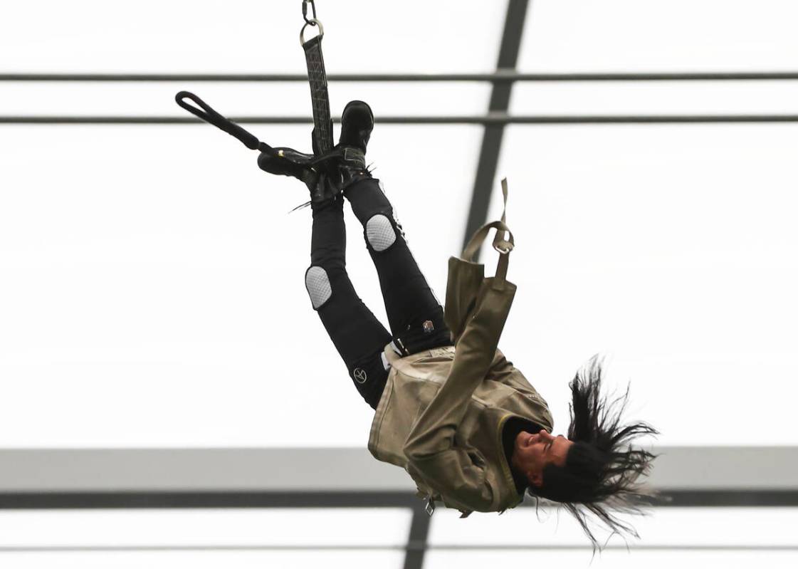 Magician and "Mindfreak" star Criss Angel, dangling over 100 feet in the air in Alleg ...