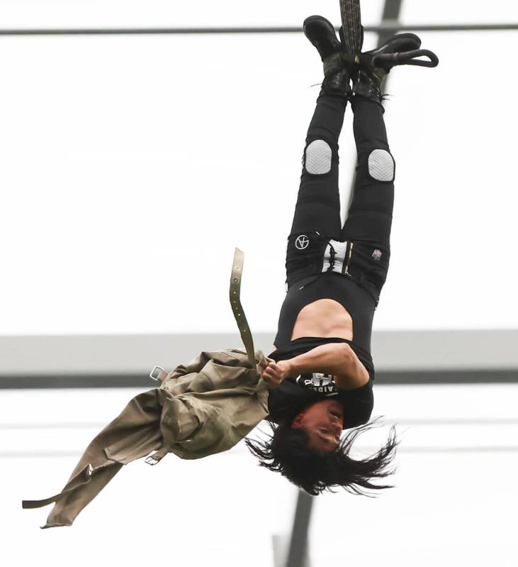 Magician and "Mindfreak" star Criss Angel, dangling over 100 feet in the air in Alleg ...