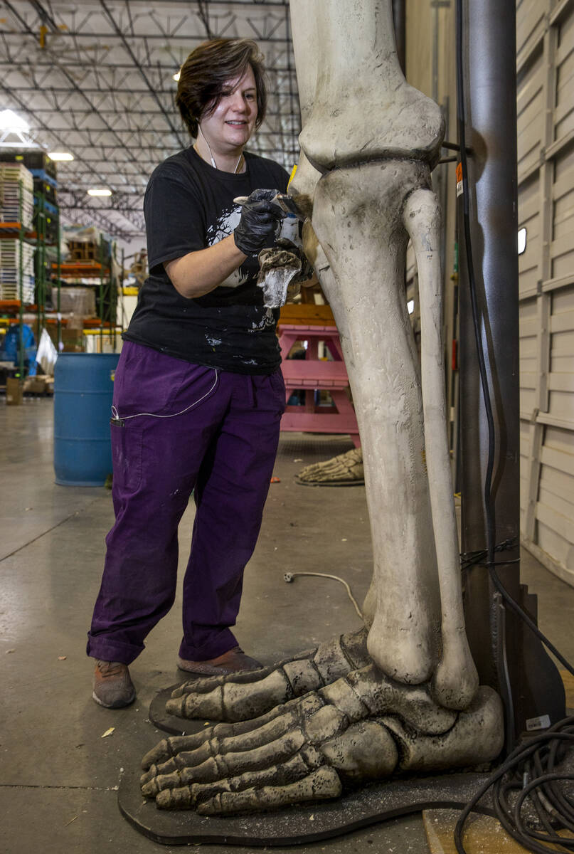 Scenic artist Wendy Eberhardt-Patrick paints giant skeleton bodies within the Electric Daisy Ca ...