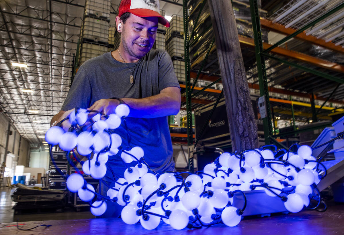 Mark Weathers with Ultimate Lighting inspects numerous strands of lights to be used for backdro ...