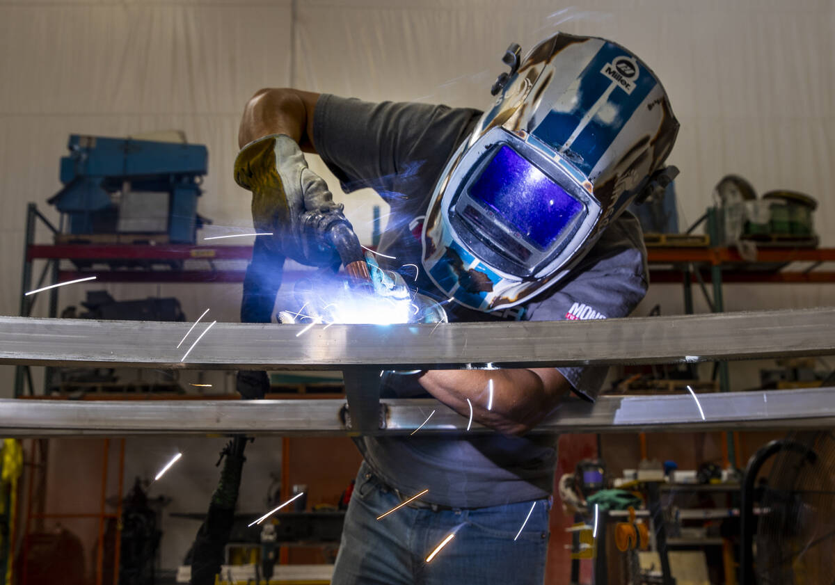 Oliver Garcia spot welds some set framing within the Electric Daisy Carnival warehouse on Thurs ...