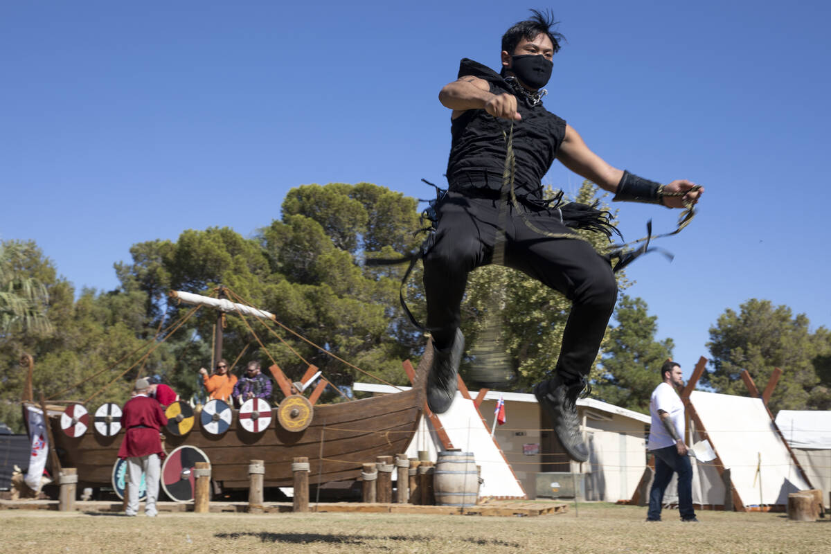 Kai Aquino practices flow arts with a rope dart during the Age of Chivalry Renaissance Festival ...