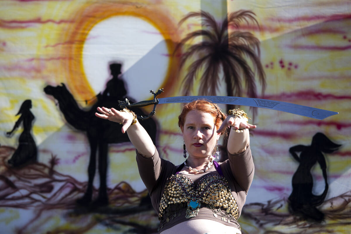 Kelley Blatnik, who owns a Las Vegas law firm, balances a sword on her head for an audience dur ...