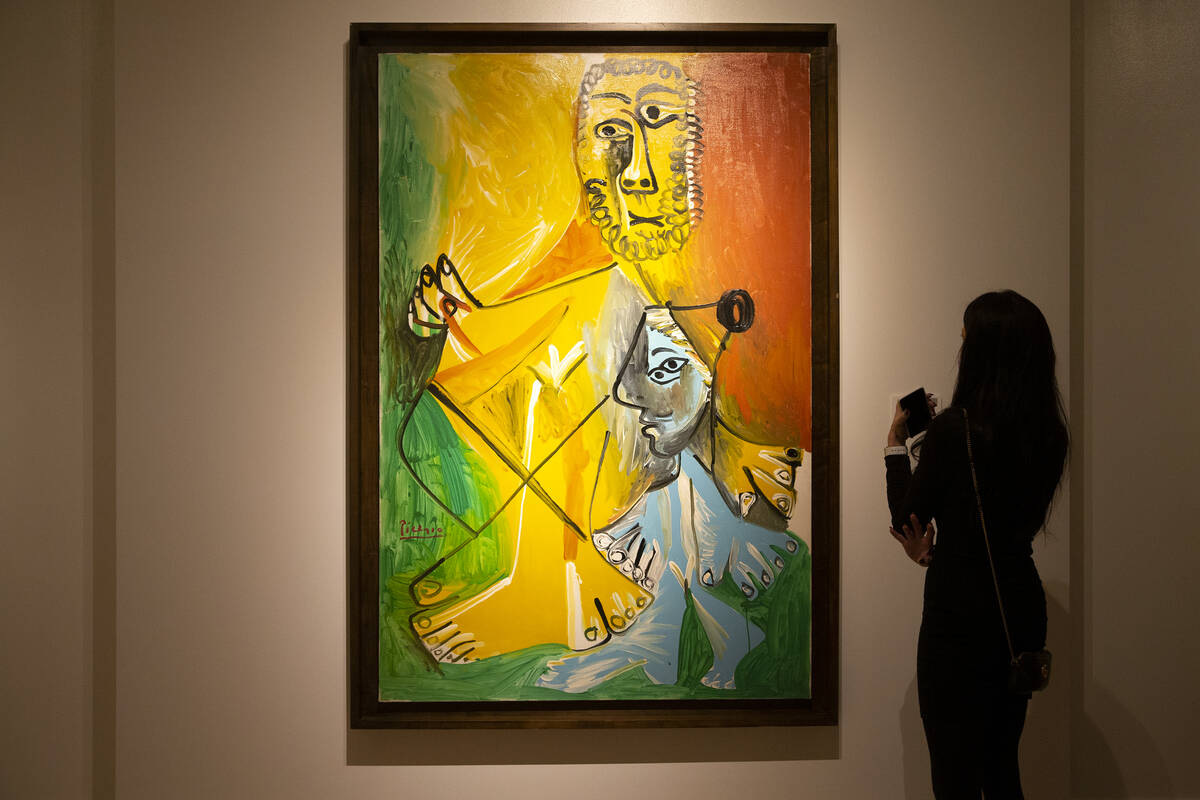 A visitor views Pablo Picasso's "Homme et enfant" at the Bellagio Gallery of Fine Art on Friday ...