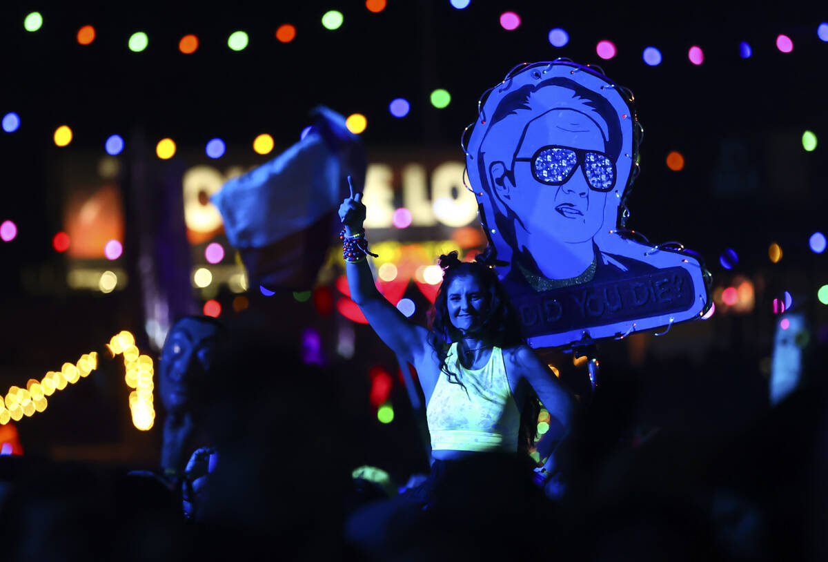 People dance as Kaskade performs at the Kinetic Field stage during the final day of the Electri ...