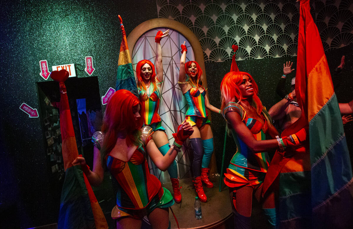 Costumed performers dance in the Queen Bar during the second day of the Electric Daisy Carnival ...