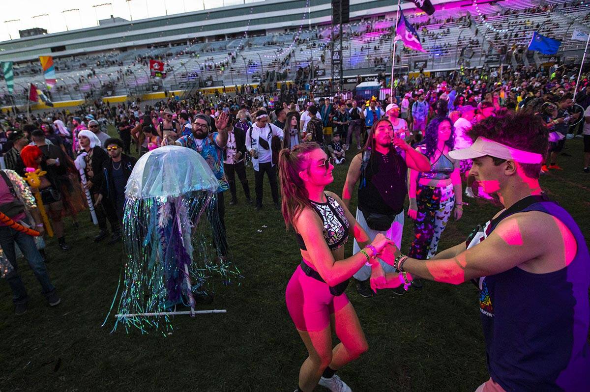 Alexis Hansen, center, and Dakota Ripka, both of Minnesota, dance at the Cosmic Meadow stage du ...