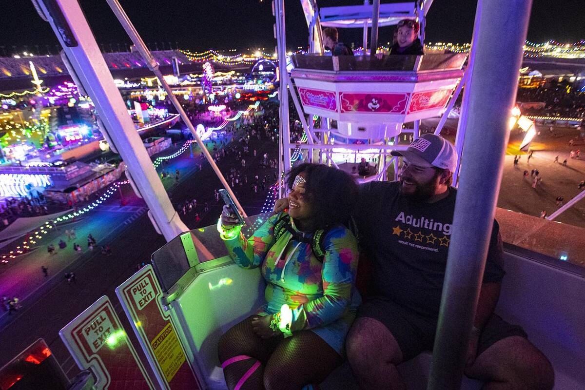 Asha Copper, left, and Zack Correll, both of Charleston, S.C., take in the sights from a ferris ...