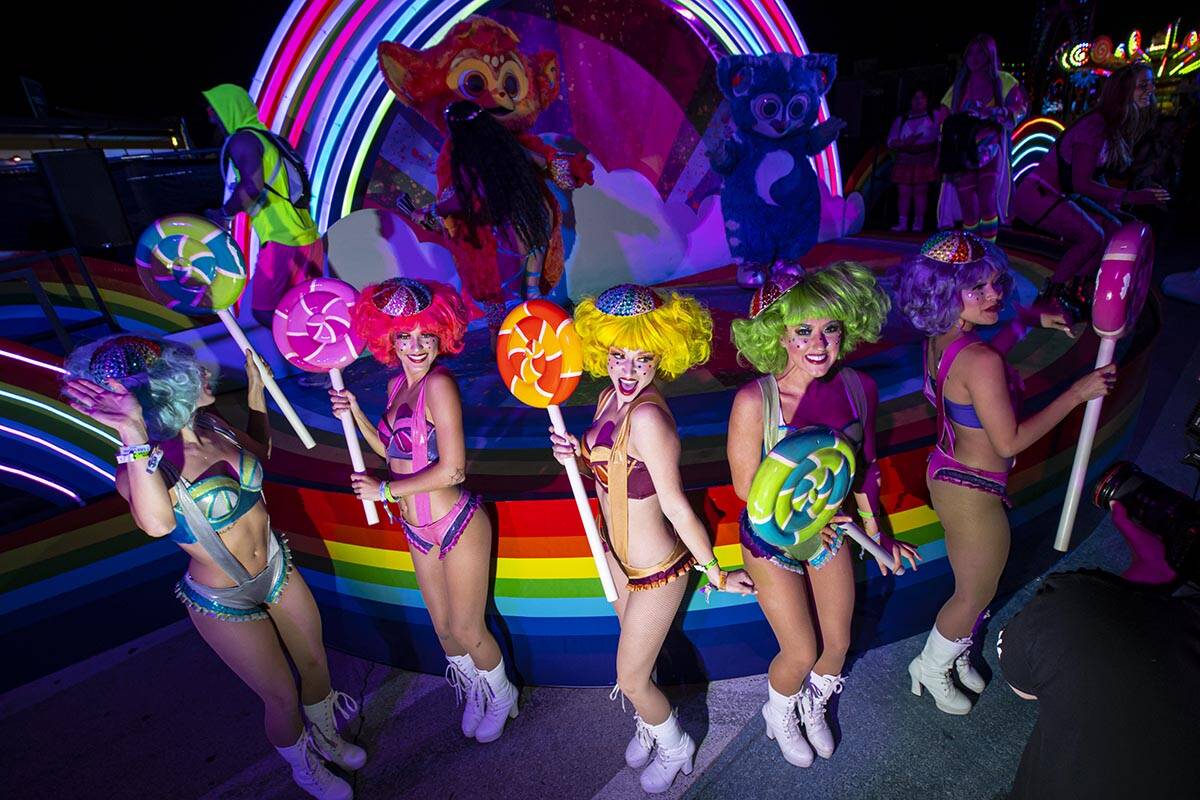 Costumed performers pose for pictures during the first day of the Electric Daisy Carnival at th ...