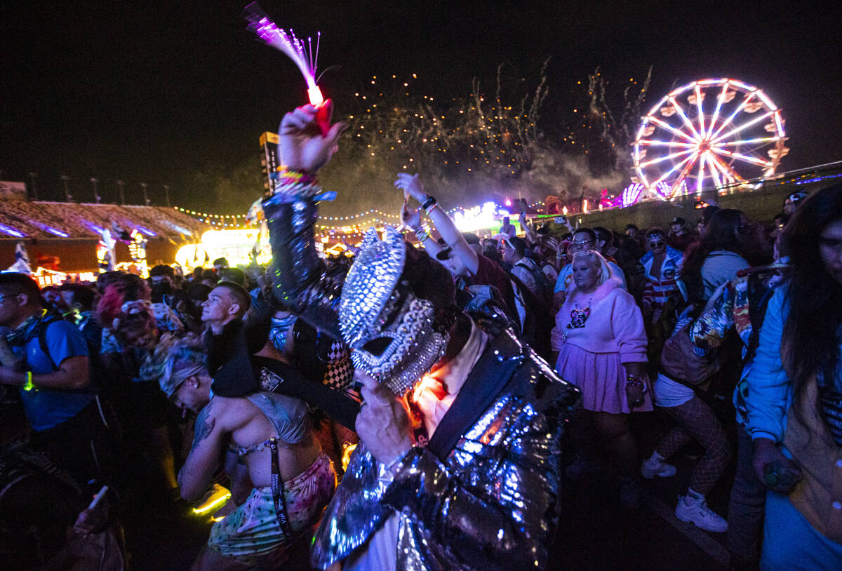 Attendees dance as Illenium performs a suprise set at the Forest House art car during the first ...