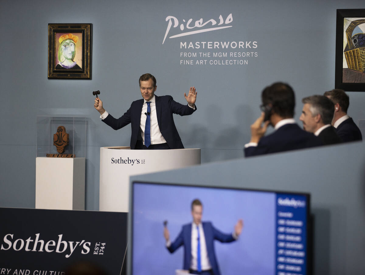 Oliver Barker, left, takes bids during an auction held by Sotheby's featuring eleven of Pablo P ...