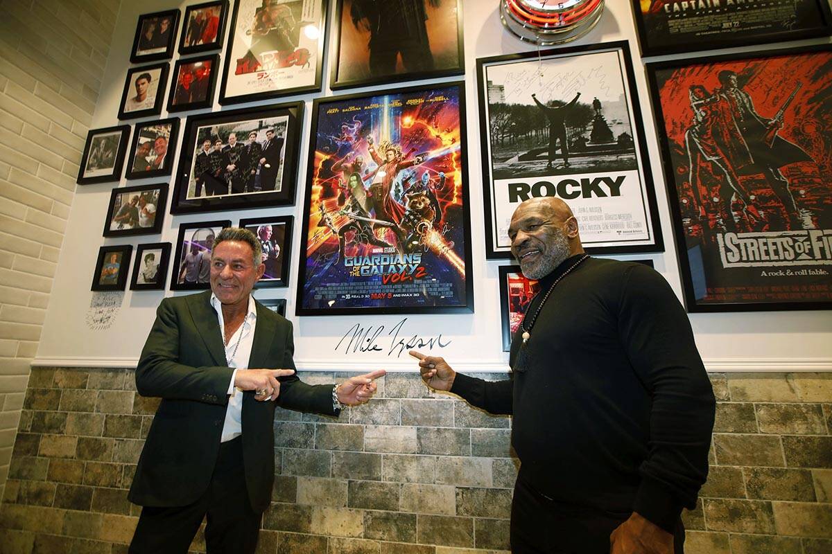 Former boxer Mike Tyson, right, poses for photos with Mulberry Street Pizzeria founder and owne ...